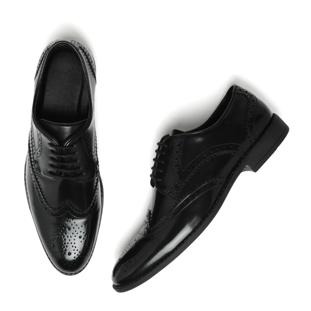 A pair of men's black leather wingtip oxford shoes with brogue detailing, shown from the top and side angles on a white background.