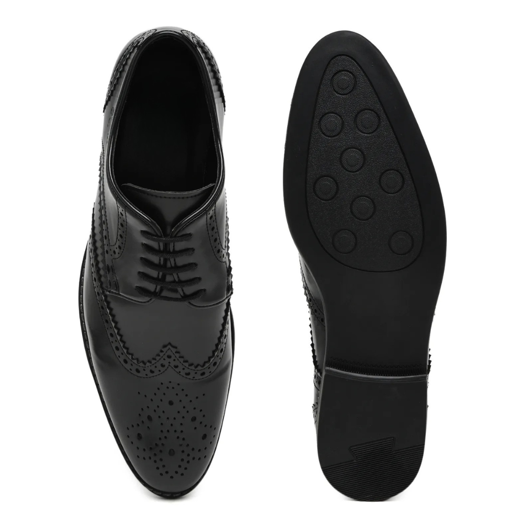 Pair of black dress shoes on a white background