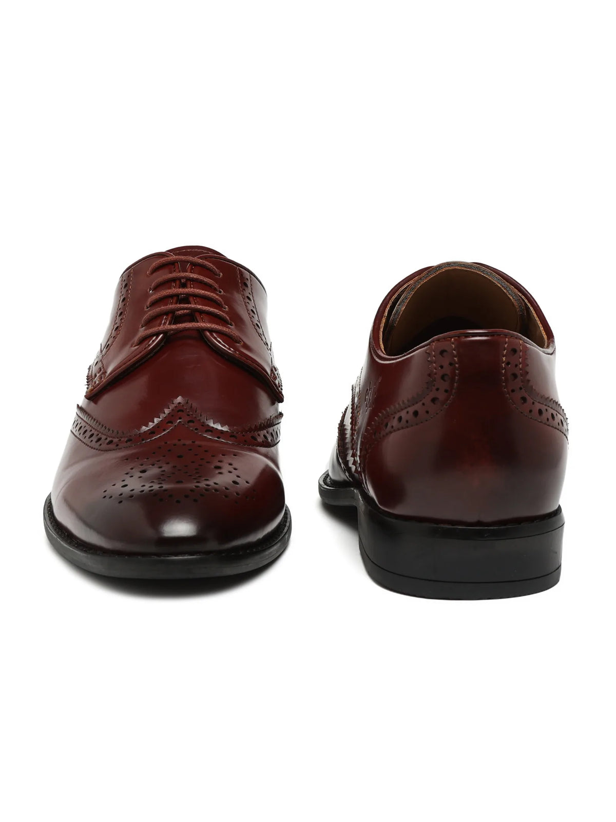 Pair of brown leather dress shoes on a white background
