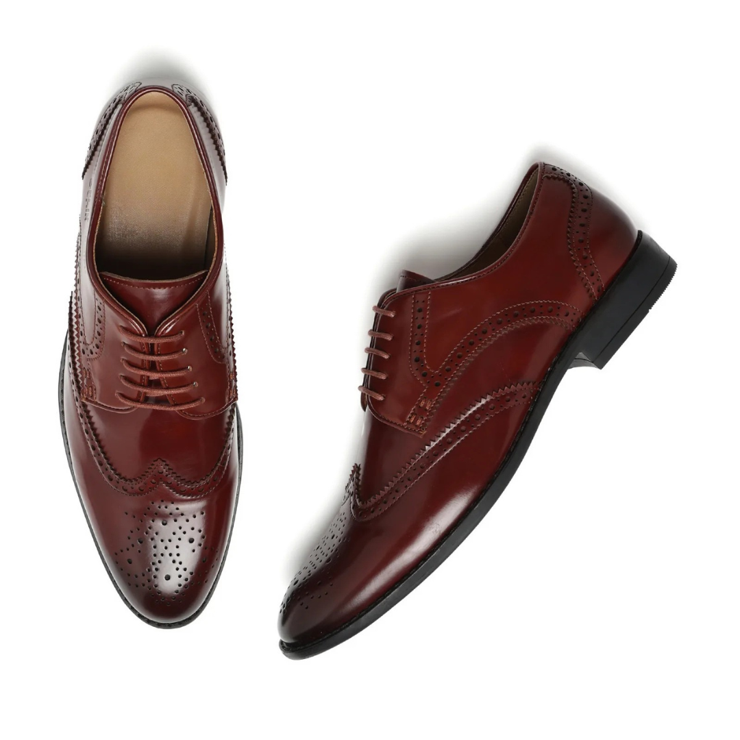 Pair of brown leather dress shoes on a white background
