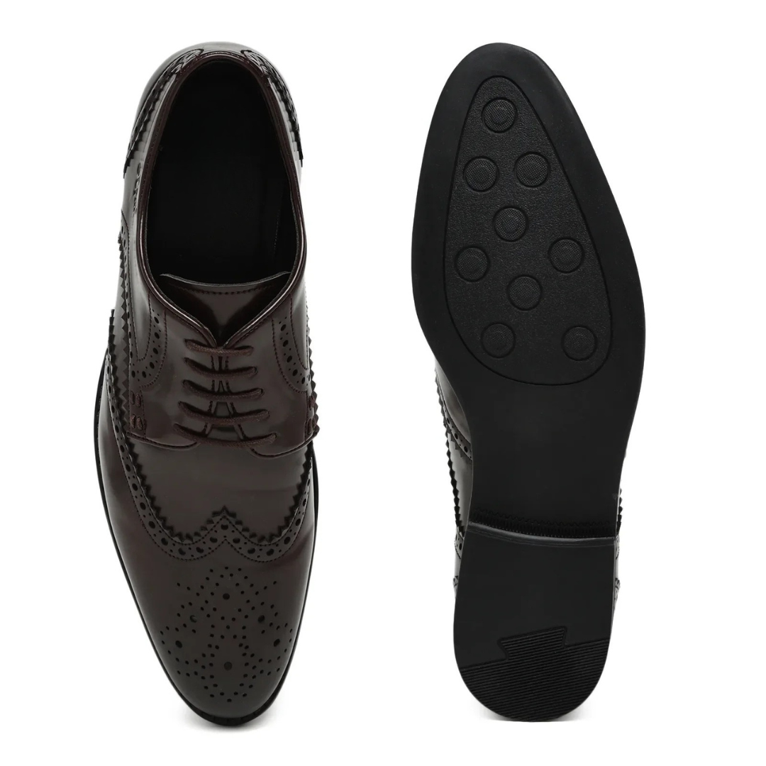A dark brown leather wingtip oxford shoe with decorative brogue perforations