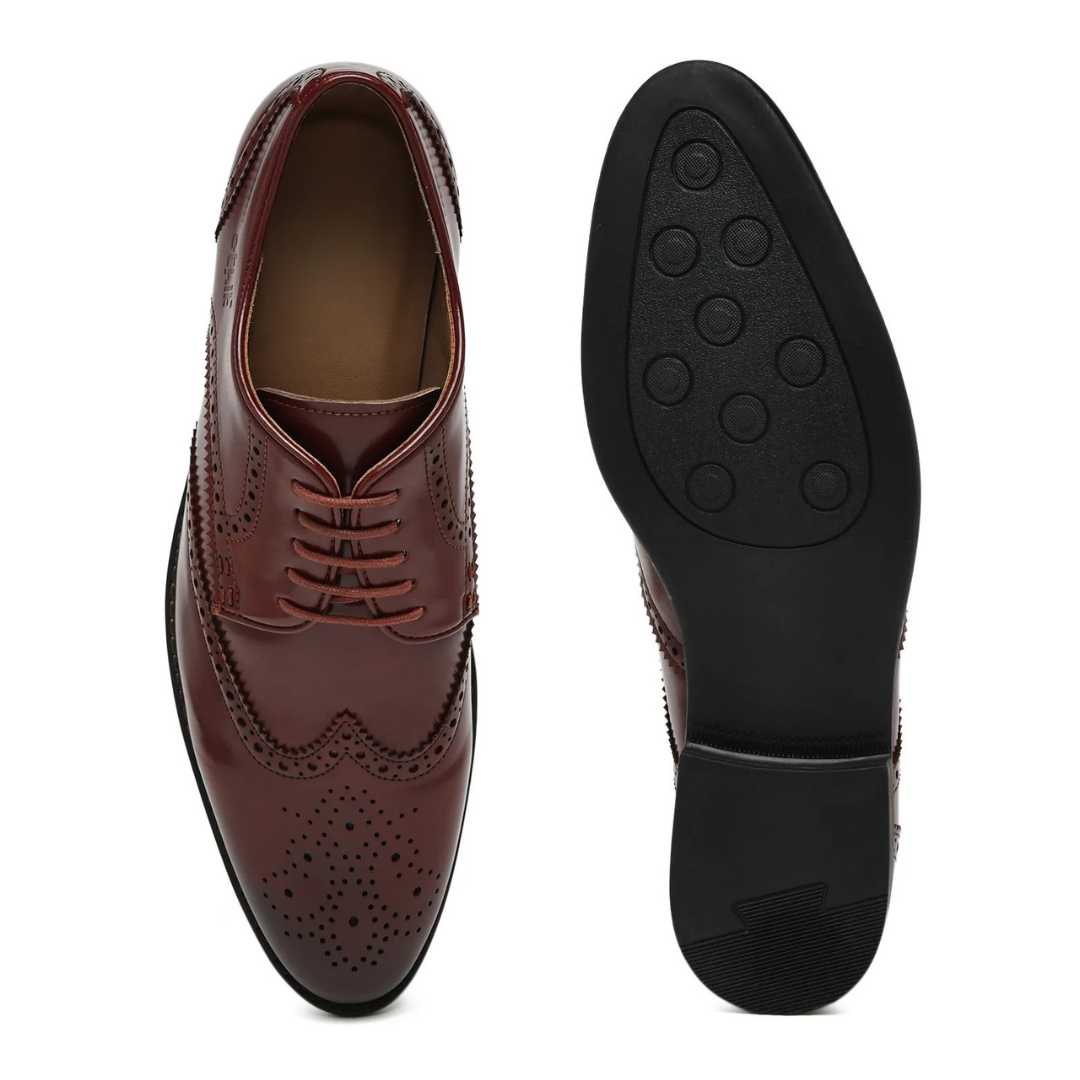 Pair of brown leather dress shoes on a white background