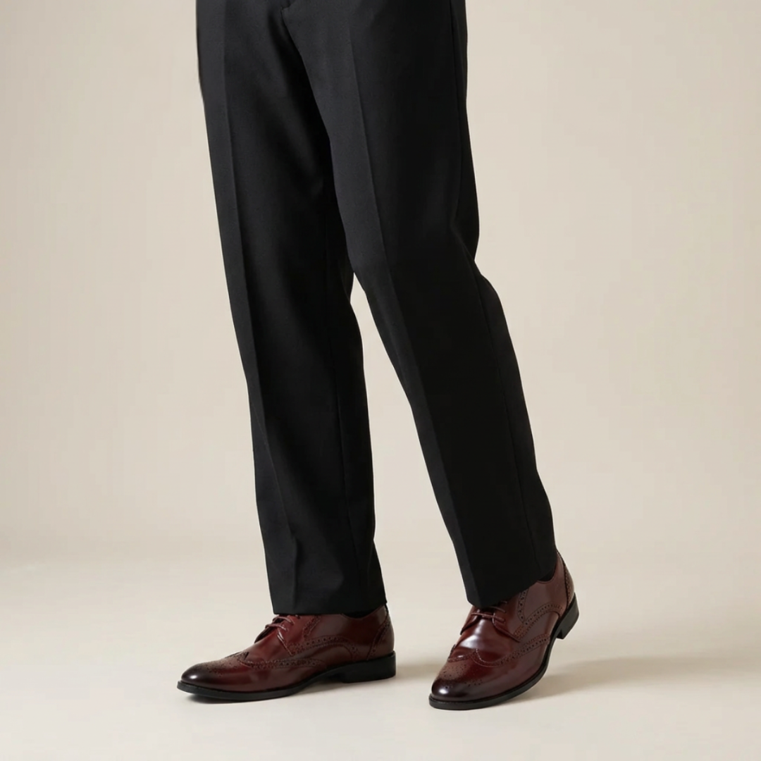 Pair of brown leather dress shoes on a white background
