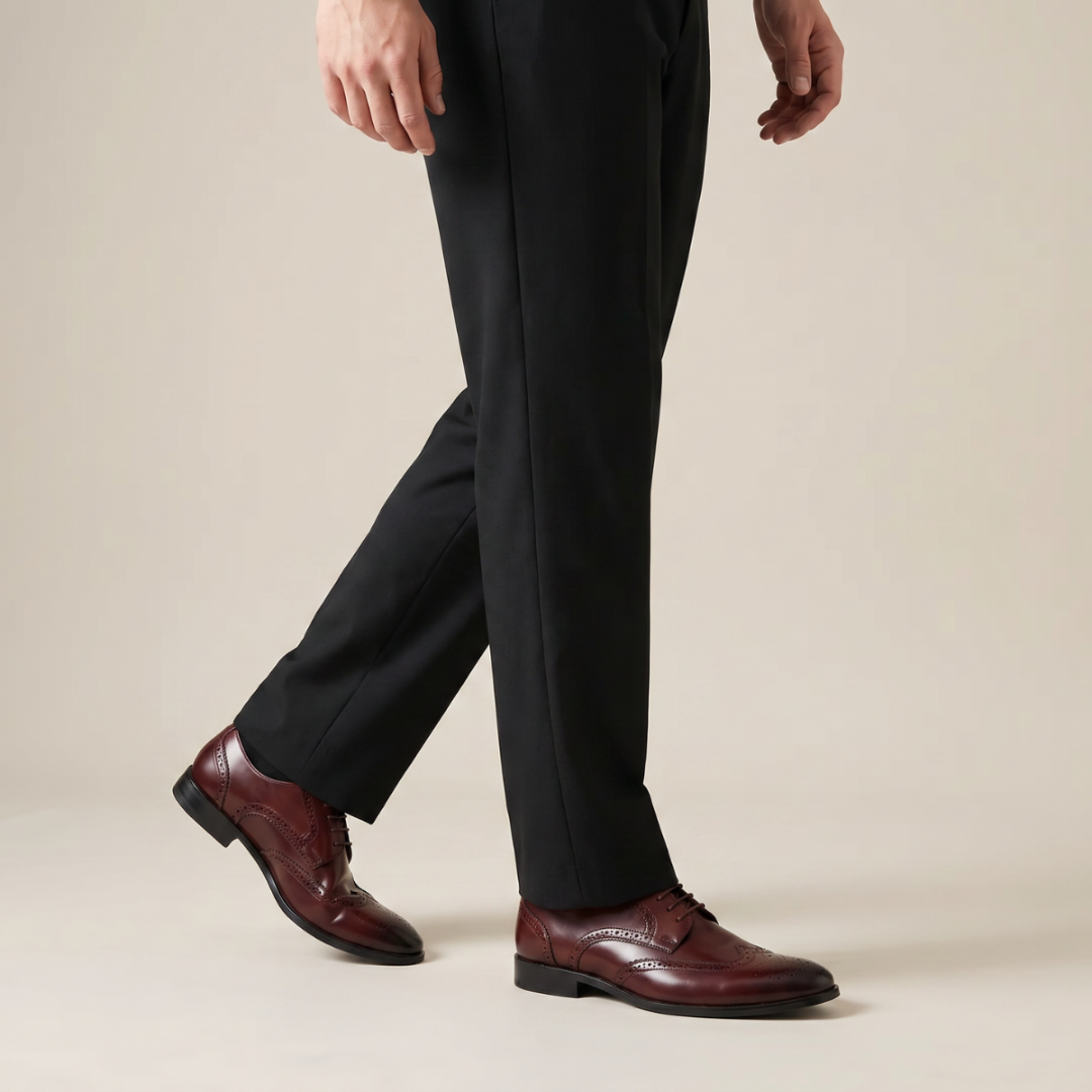 Pair of brown leather dress shoes on a white background