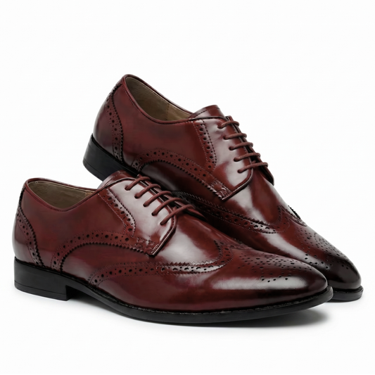 Pair of brown leather dress shoes on a white background