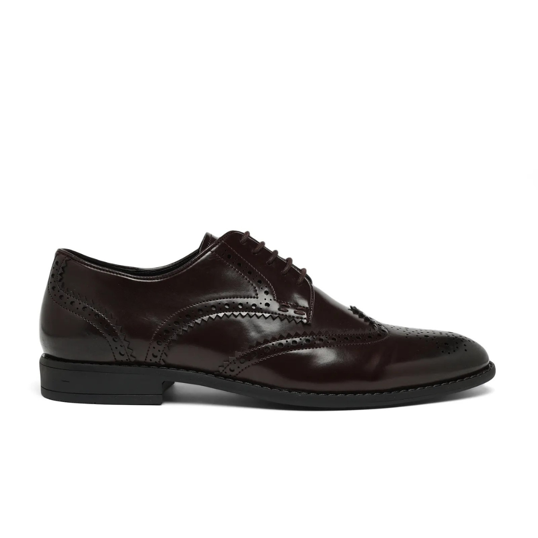 A dark brown leather wingtip oxford shoe with decorative brogue perforations, shown in a side profile view against a plain white background.