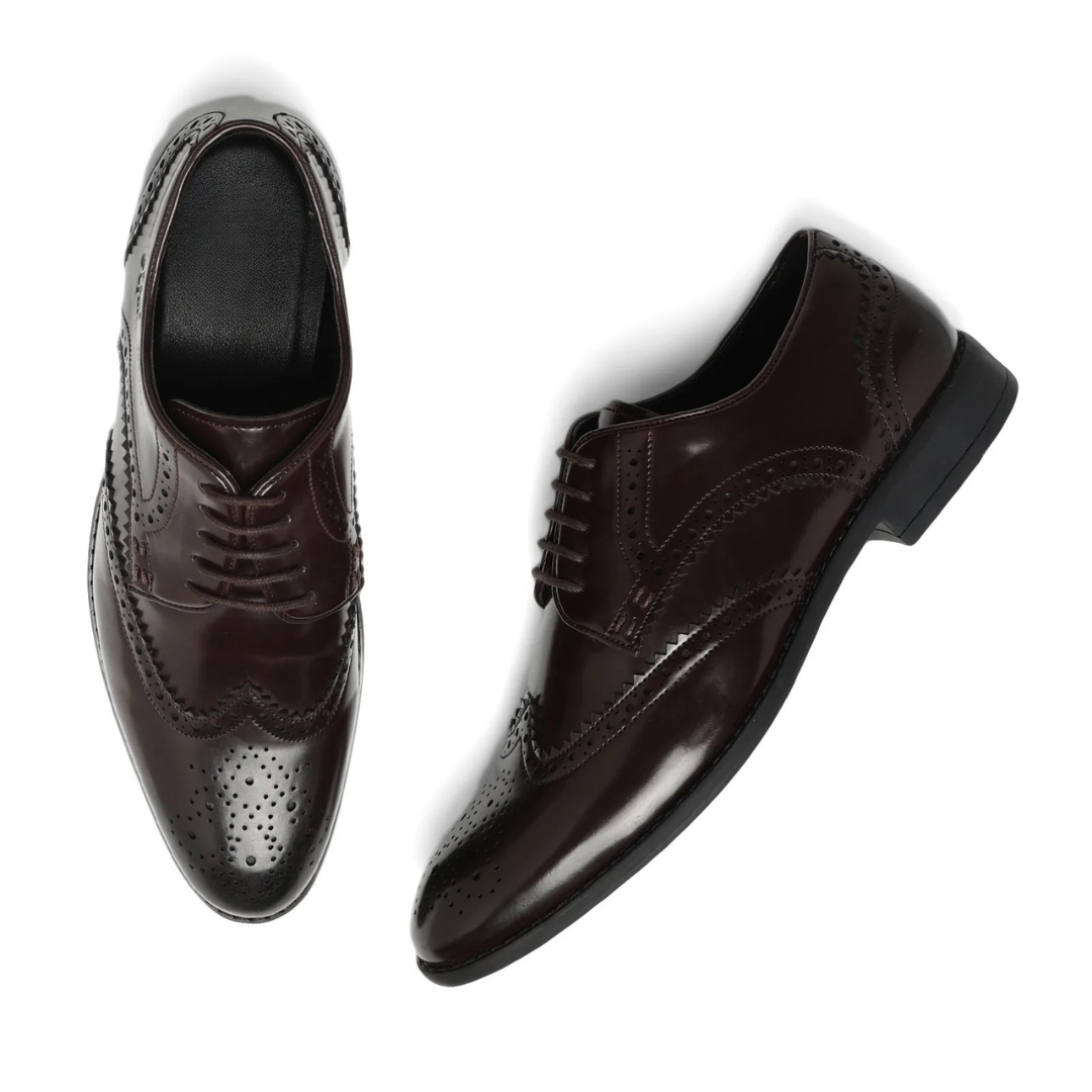 A dark brown leather wingtip oxford shoe with decorative brogue perforations