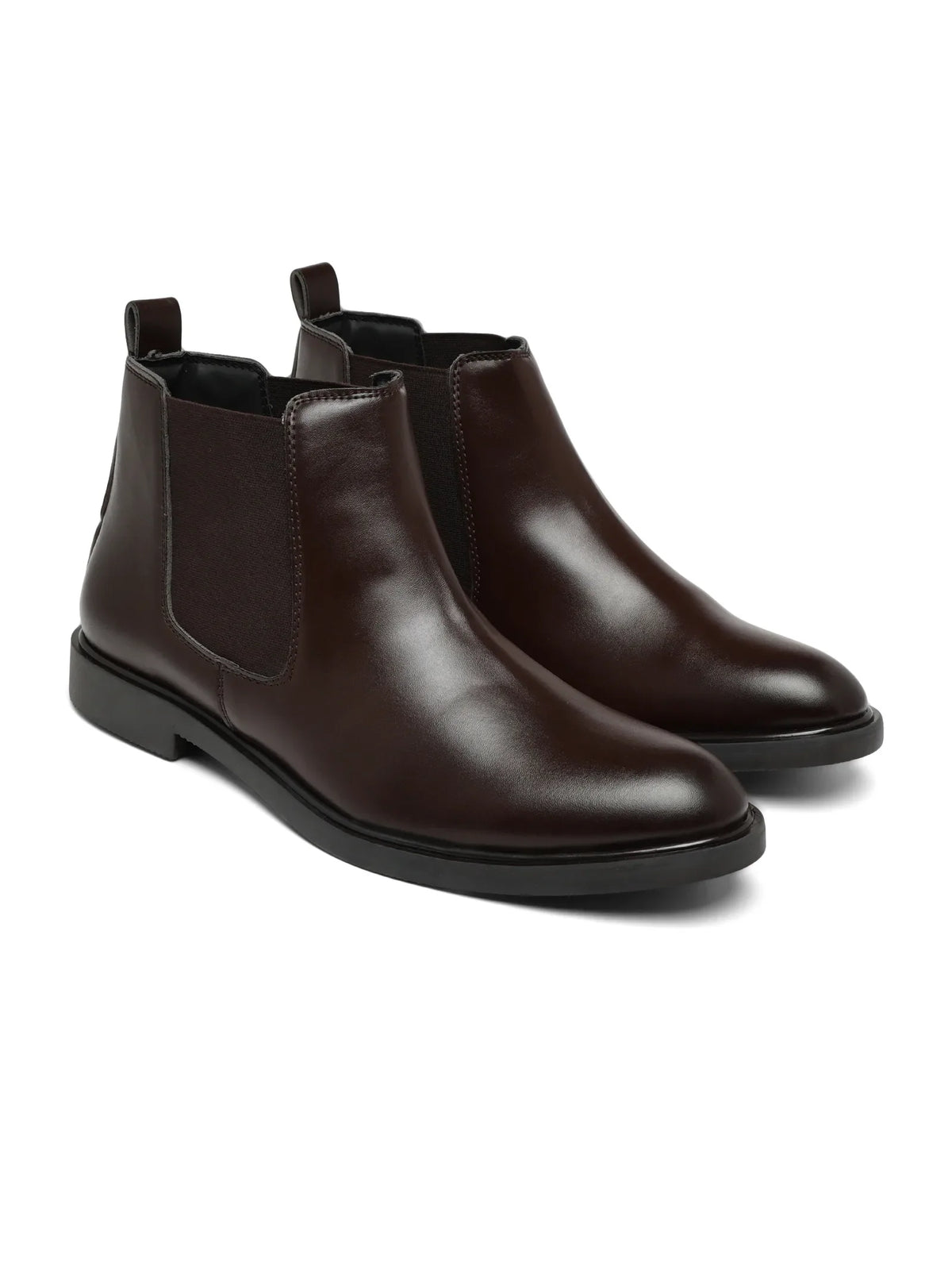 Pair of brown leather Chelsea boots on a white background