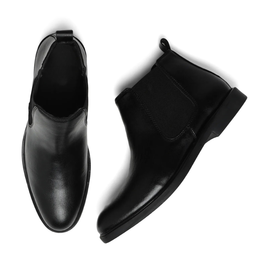 A pair of black leather Chelsea ankle boots shown from two angles: a top-down view on the left and a side profile on the right, set against a plain white background.
