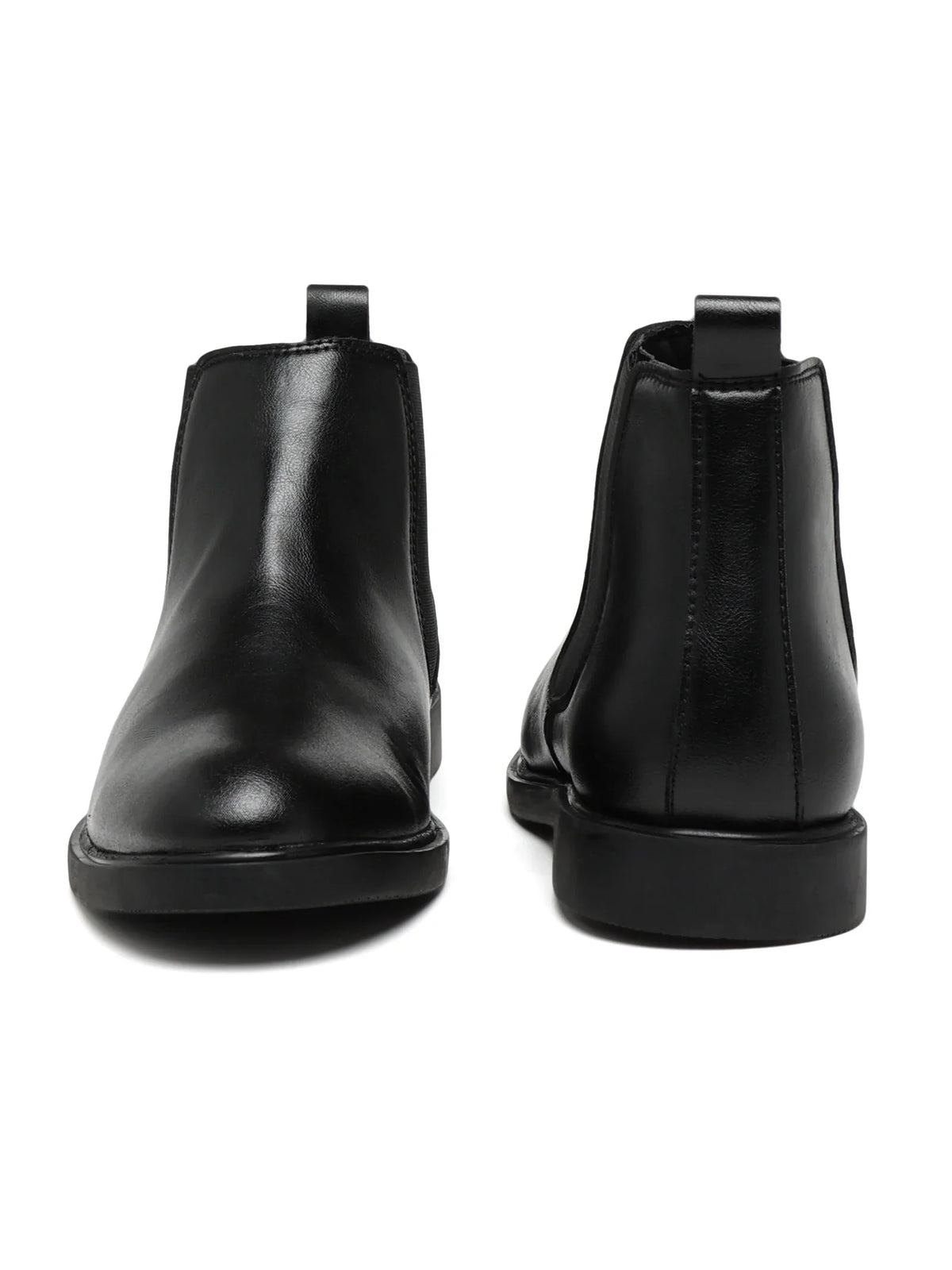 Pair of black leather Chelsea boots on a white background