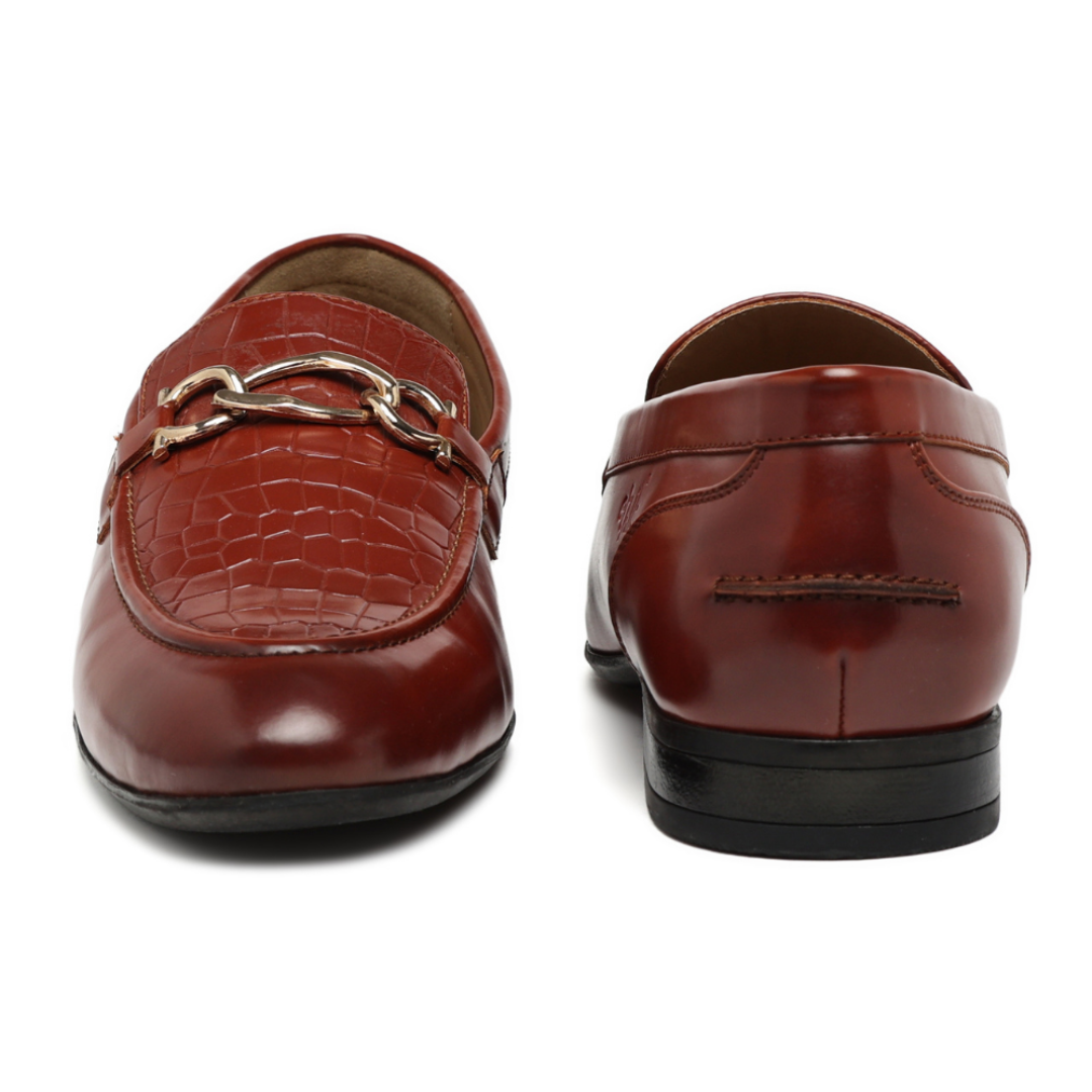 A pair of men's brown leather loafers shown from the front and back on a white background. The front loafer features a crocodile-embossed texture and a silver-tone chain detail across the vamp, while the rear view shows the heel, sole, and stitching.