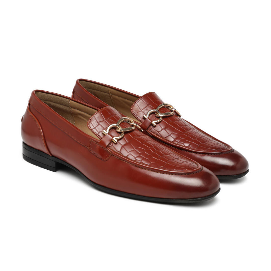 A pair of men's brown leather loafers with a crocodile-embossed pattern, featuring a gold-tone horsebit detail across the vamp and a low black heel, shown on a white background.